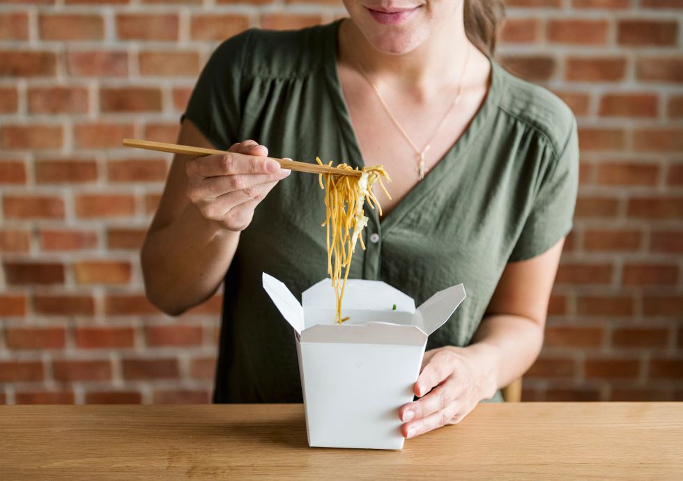 White woman eating Chow mein