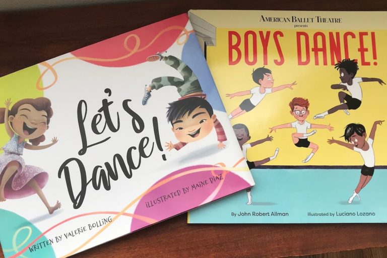 Let's Dance and Boys Dance, both colorful books featuring illustrated children dancing, lay flat on a wooden table