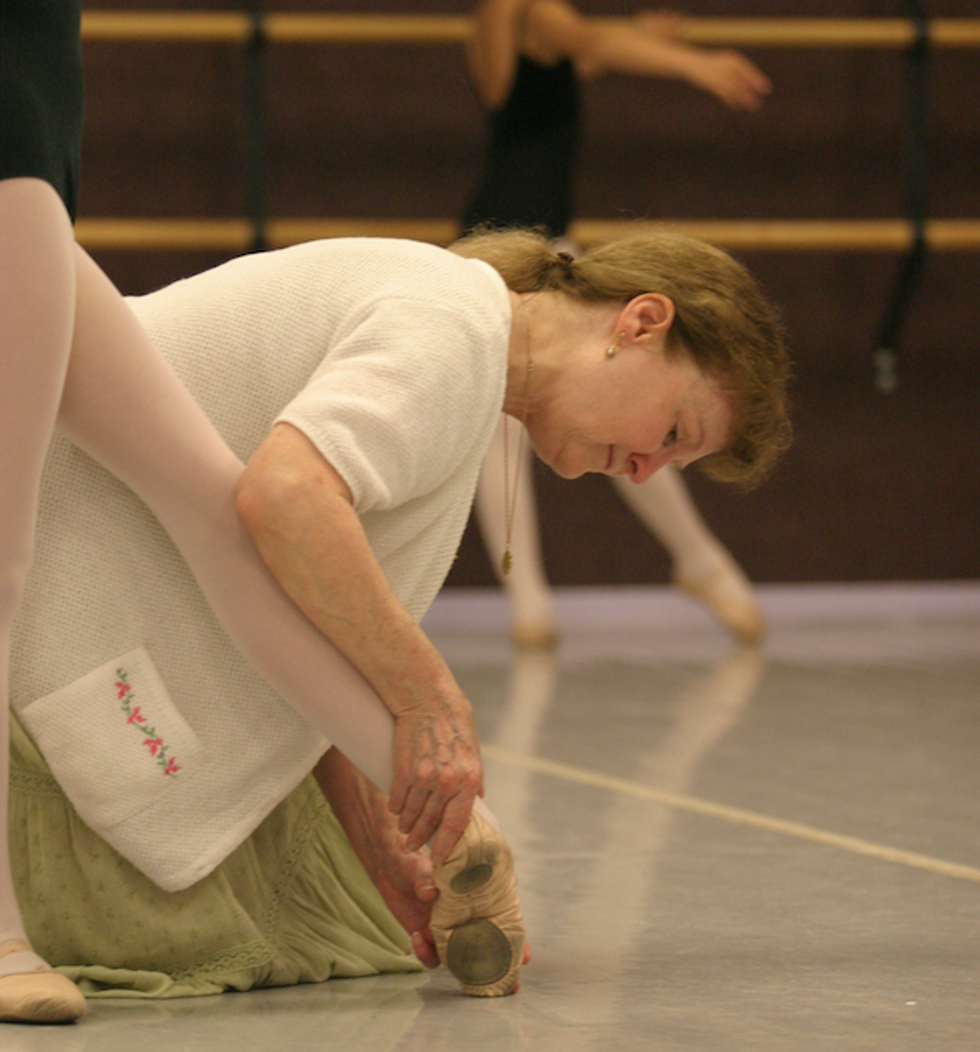 Marcia Dale Weary shaping a student's tendu at the barre