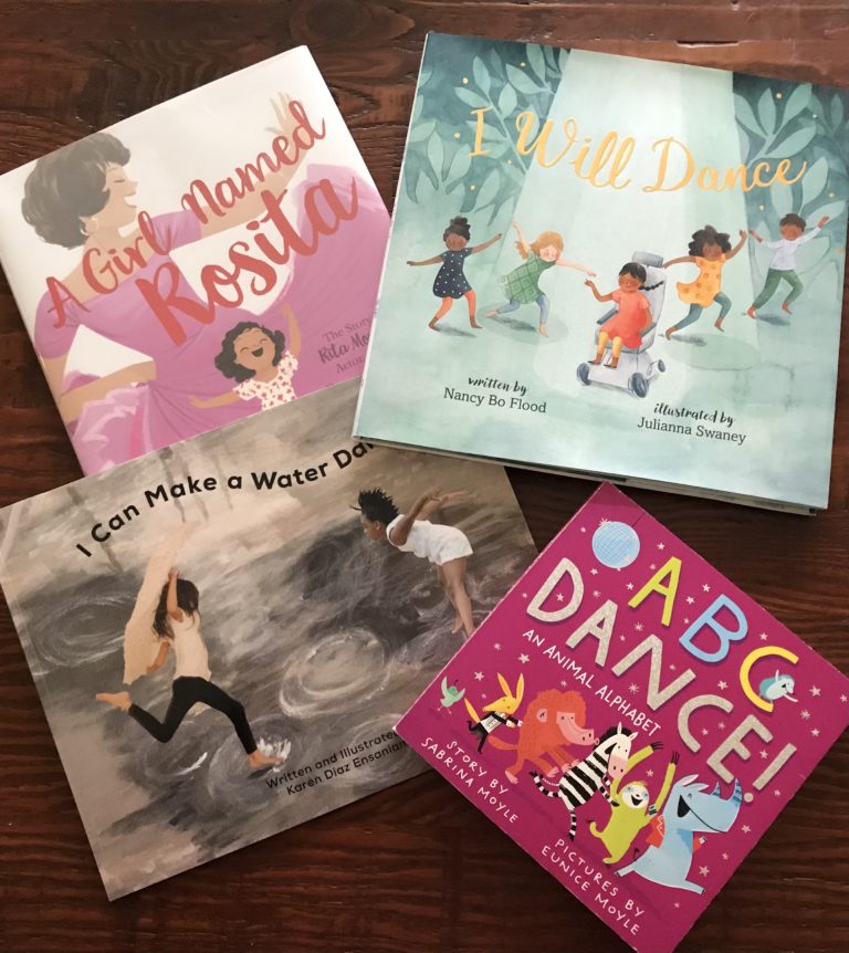Four books—I Can Make A Water Dance, A Girl Named Rosalita, ABC Dance! and I Will Dance—splayed on a wooden table.