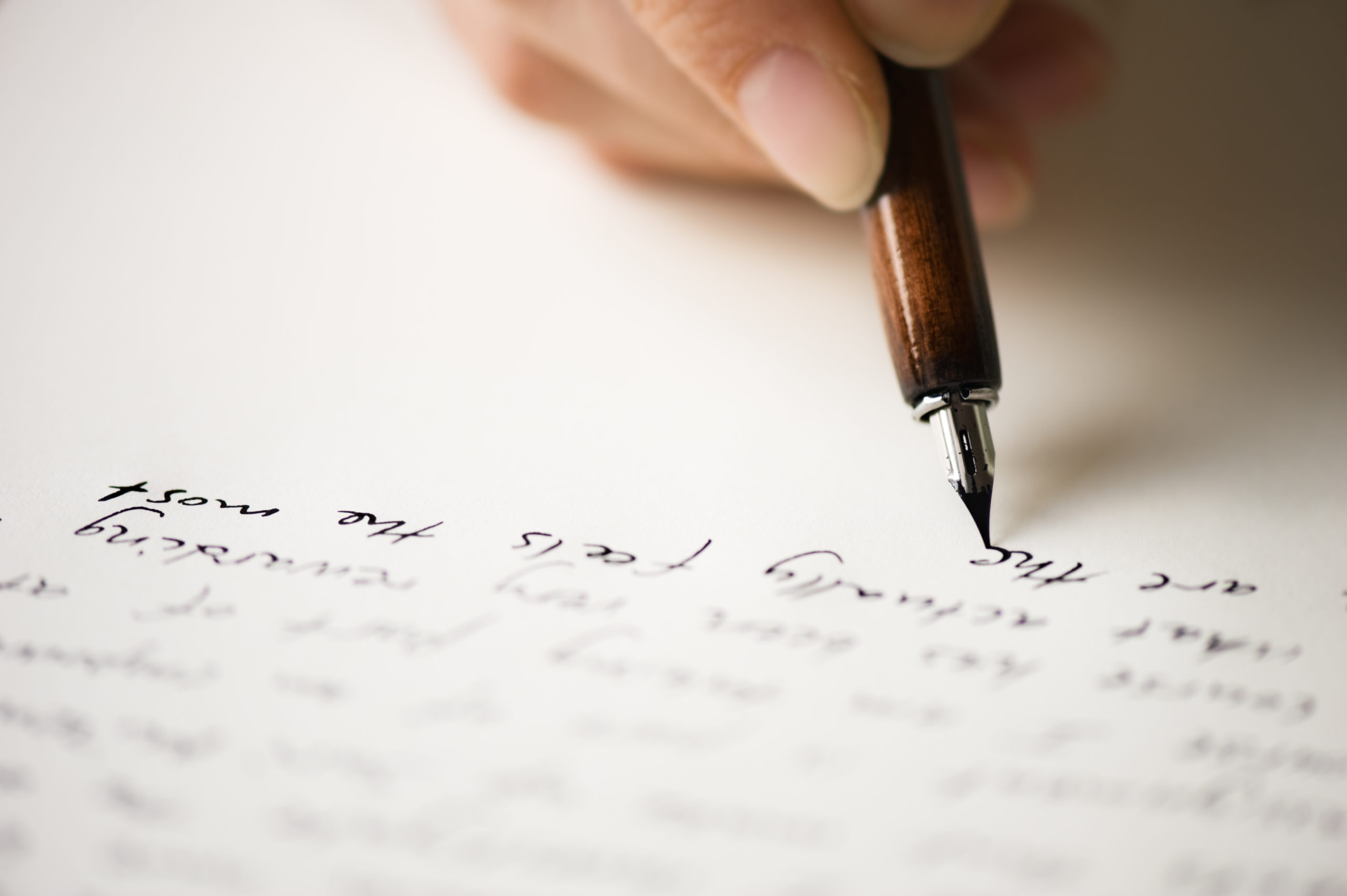 Writing a handwritten letter with pen and paper