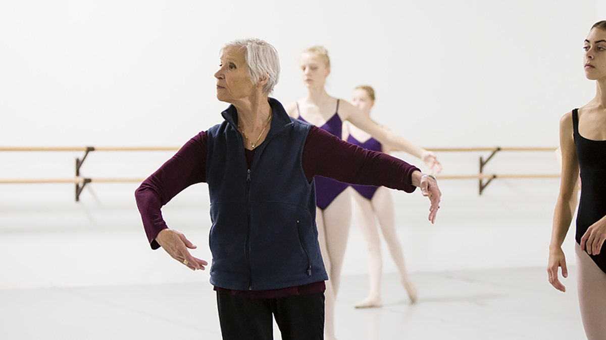 Image of dance educator Lirena Branitski teaching in a studio with her arms in 3rd position