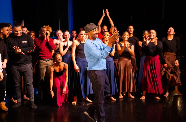 Image of dance educator Earl Mosely on stage with a group of dance artists