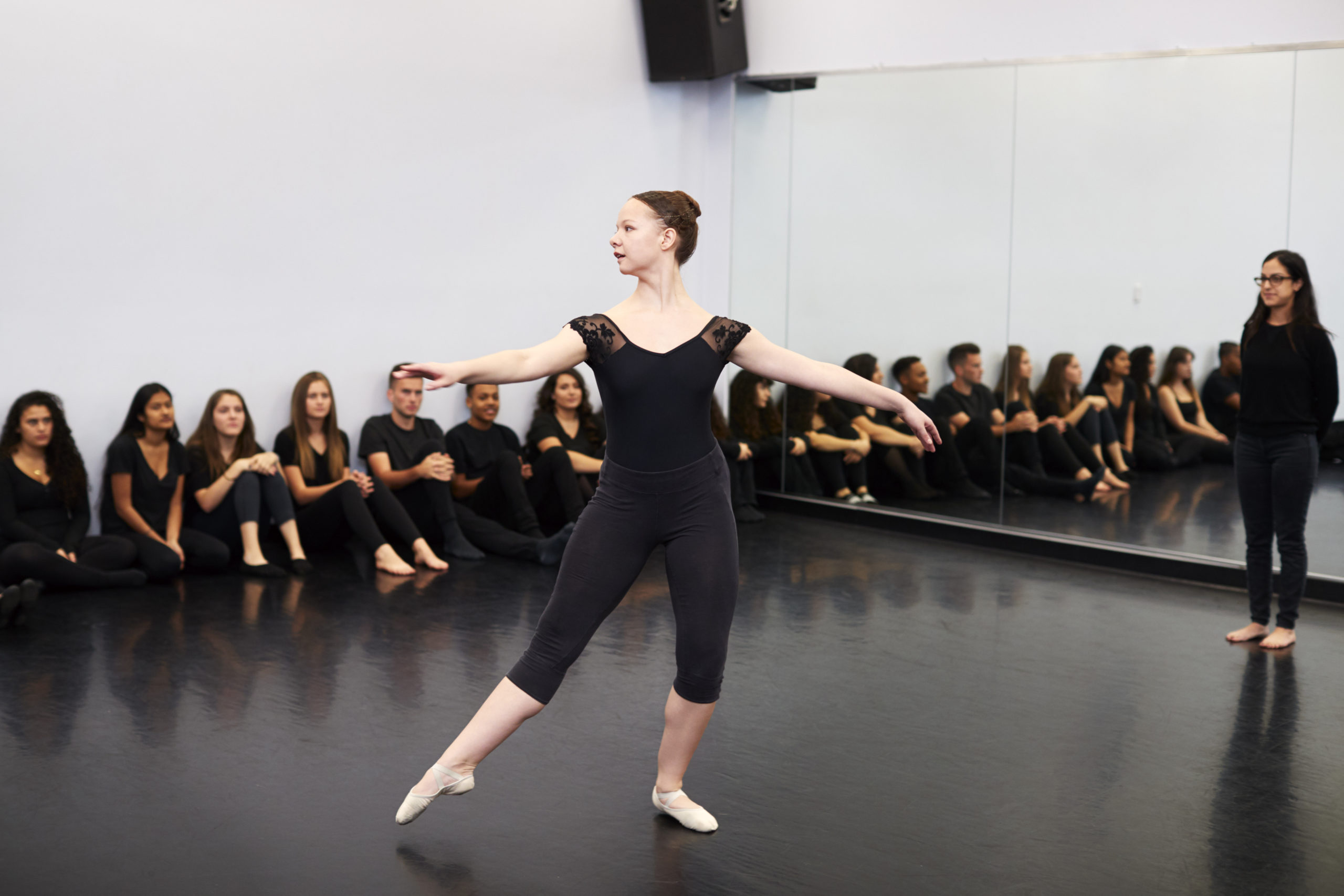 Female Ballet Student At Performing Arts School Performs For Class And Teacher In Dance Studio