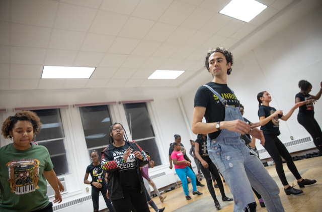 Image of choreographer and performer Caleb Teicher teaching a group of students