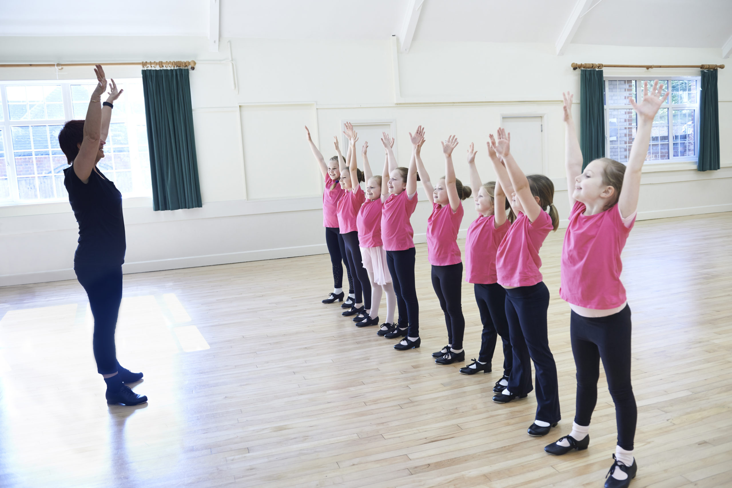 Group Of Girls In Tap Dancing Class With Teacher