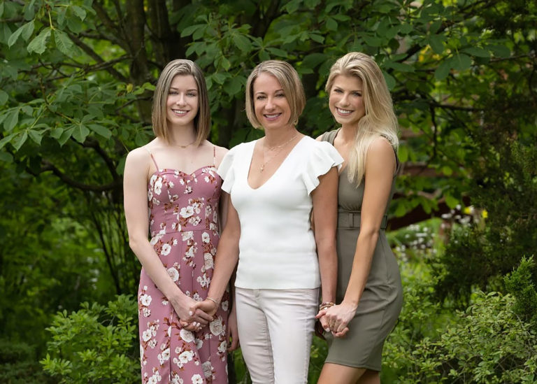 Three women against a grassy backdrop