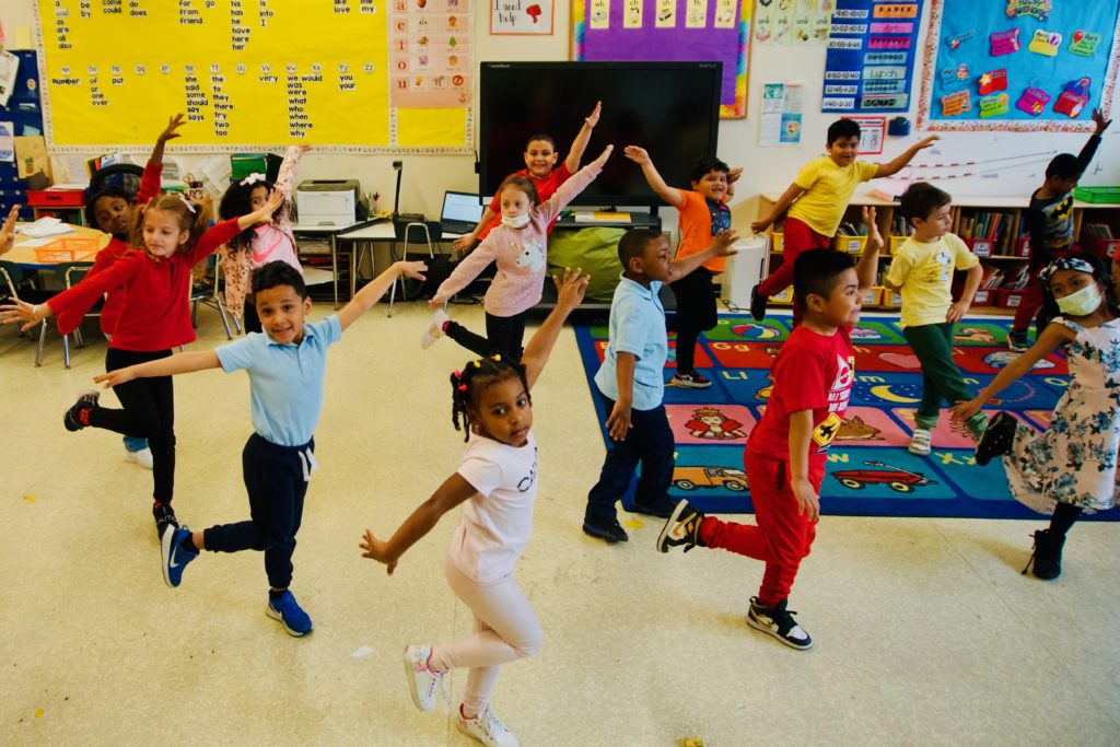 Students in K-12 dancing in the classroom