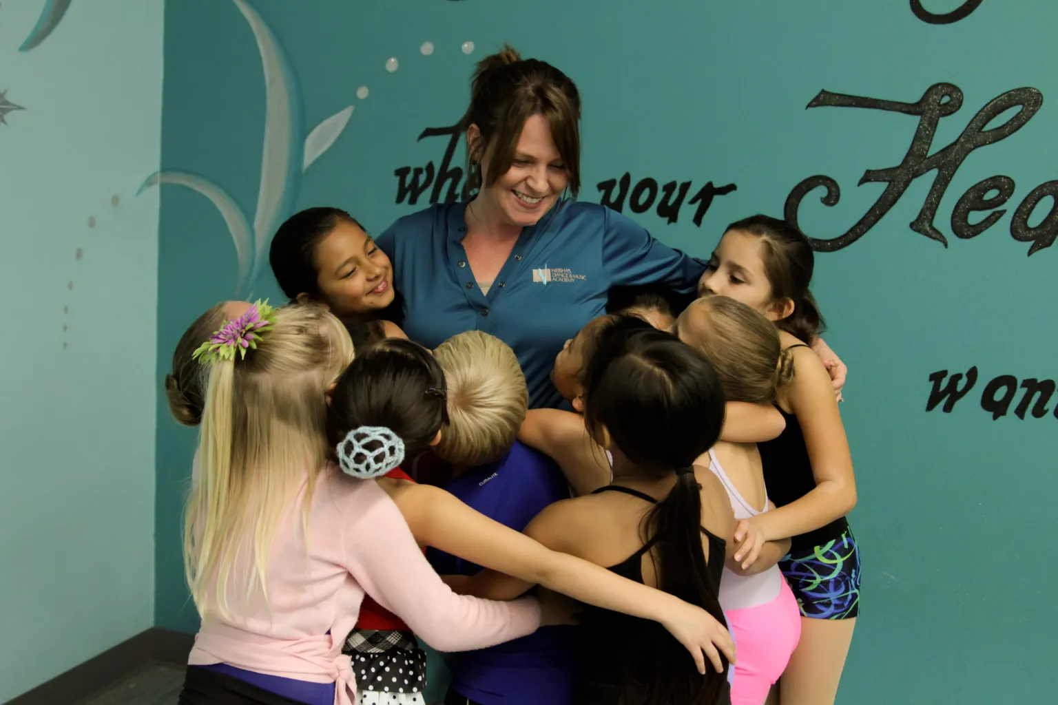 Photo of dance educator with a group of students