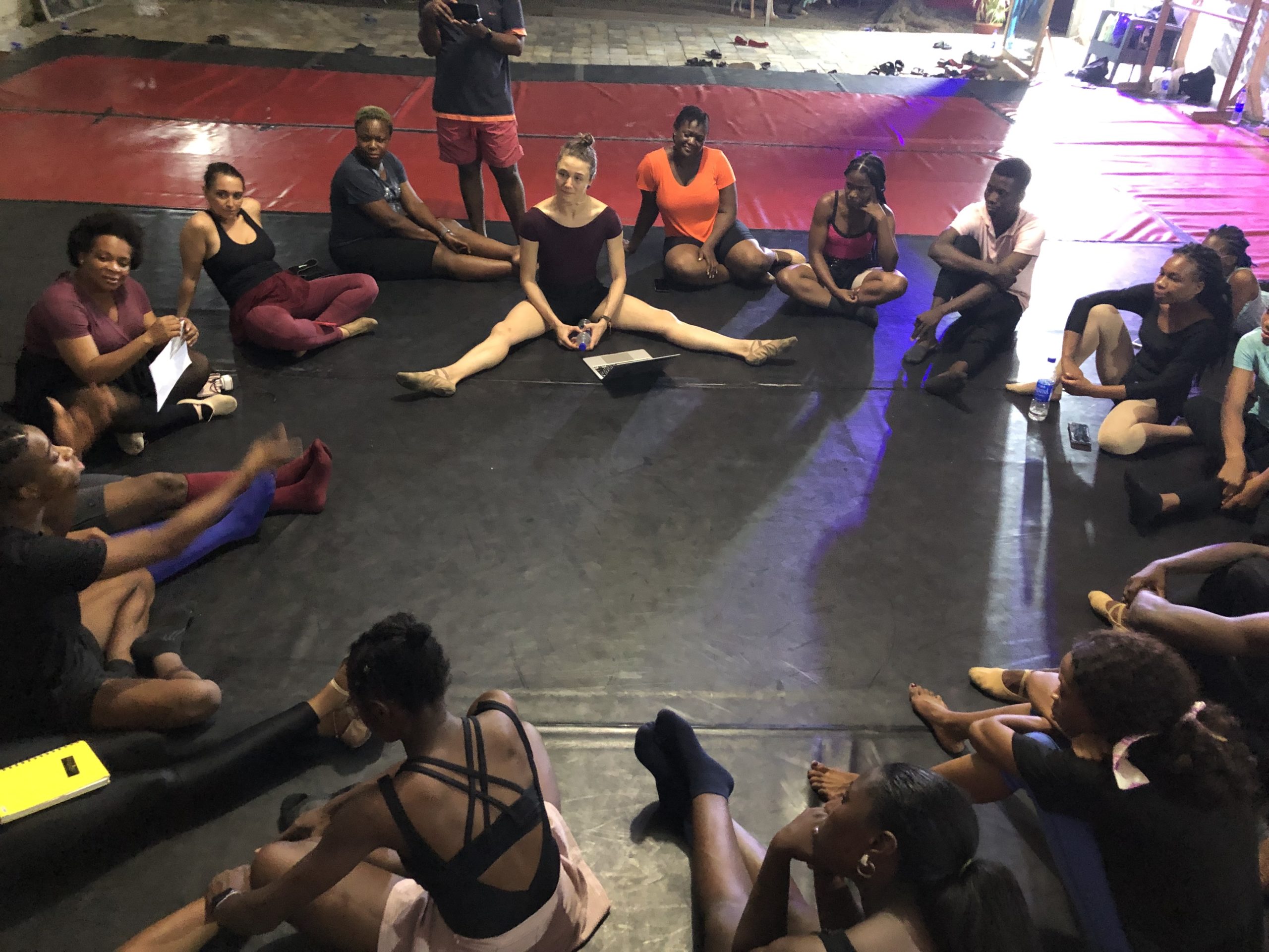 Group of dance educators sitting on the floor in a circle