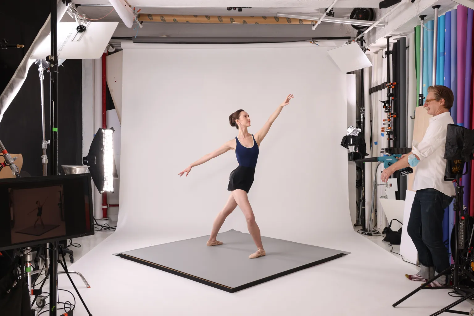 Image of dancer posing on a Harlequin floor at a photo shoot