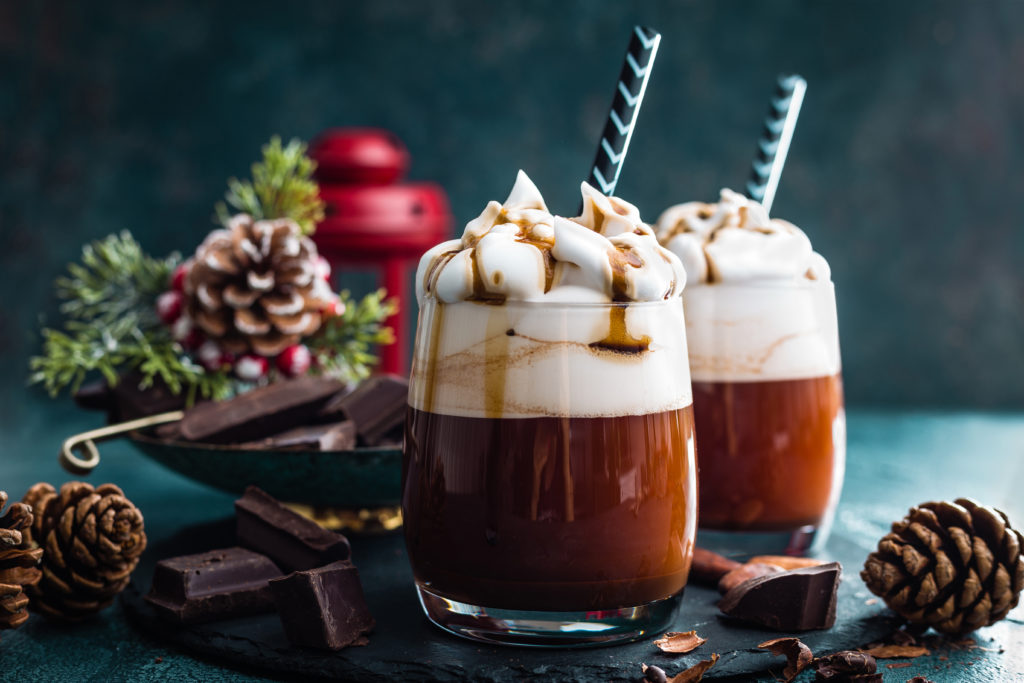 Hot chocolate with whipped cream among festive decorations