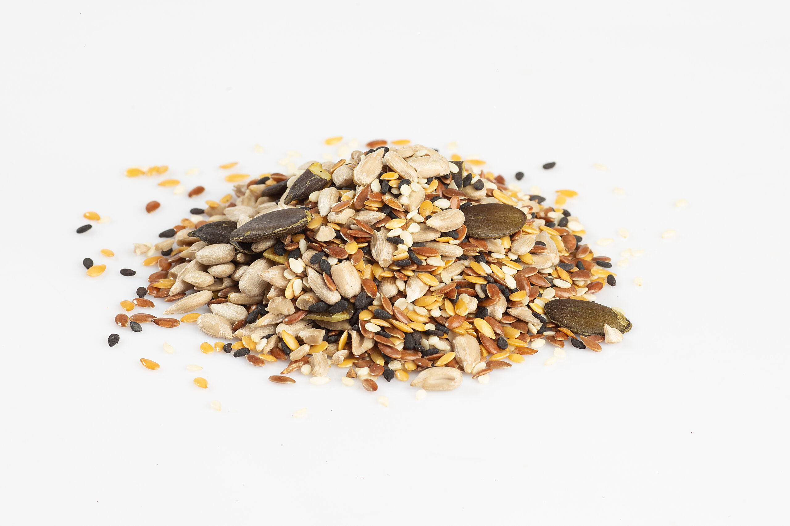 Raw seeds mix against white background.