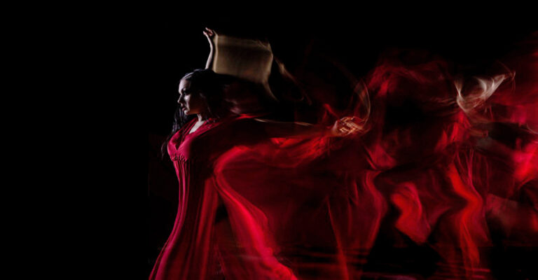 Art photo of Anya Katsevman in a red dress, slightly blurred.