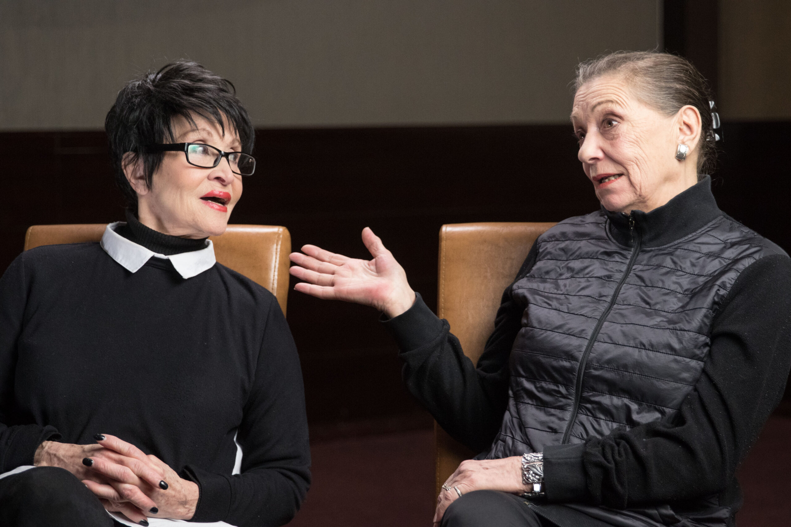 Chita Rivera and Graciela Daniele sit in leather chairs side by side, deep in conversation.