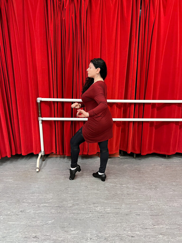 Anya Katsevman demonstrates at a bar against a red background.