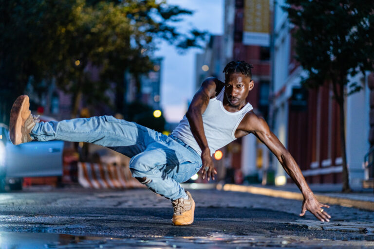 Dancer Omari Wiles holding a pose on the street