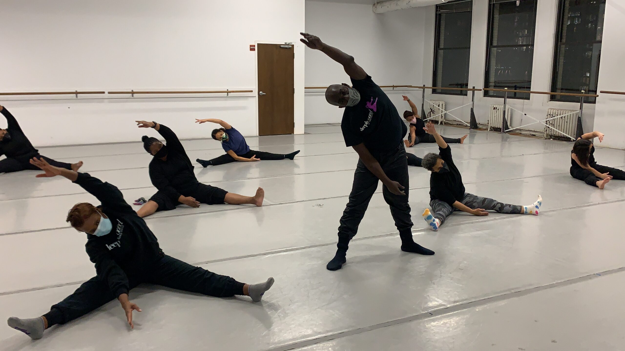 Dance educator Derek Whiturs teaching a class of adult dance students.