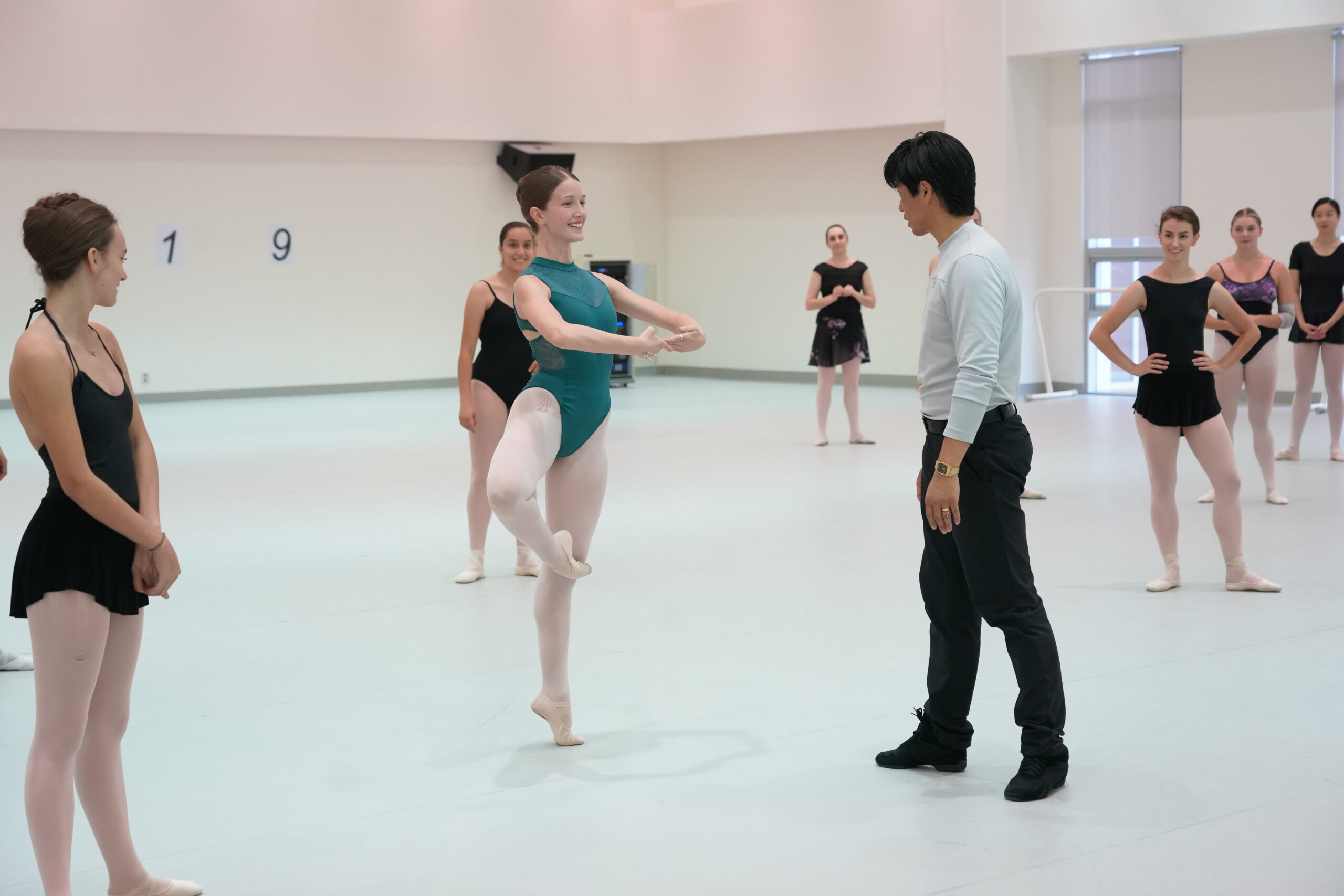Dance educator Jay Jong-Hoon Kim teaching a class of ballet students.