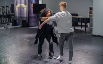 Maria Torres dancing with a student.
