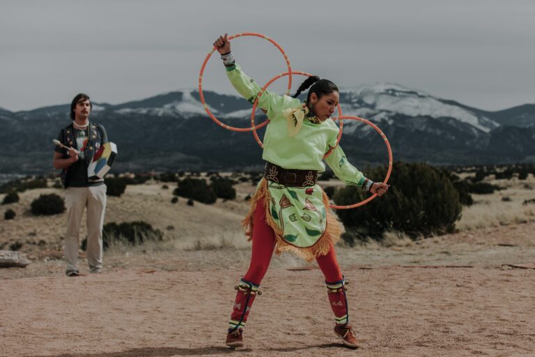 ShanDien Sonwai LaRance performing hoop dance in an open area