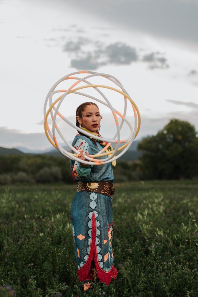 ShanDien Sonwai LaRance posing with hoops in a green field