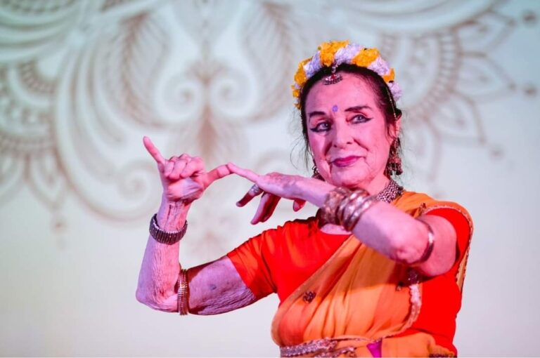 Vija Vetra miming holding a flute in indian classical dance.