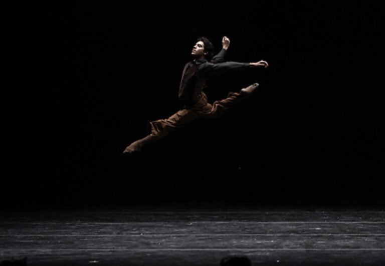 Alejandro Vargas in a leap on stage.