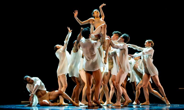 Eileen Kim being lifted in the air by a group of dancers.