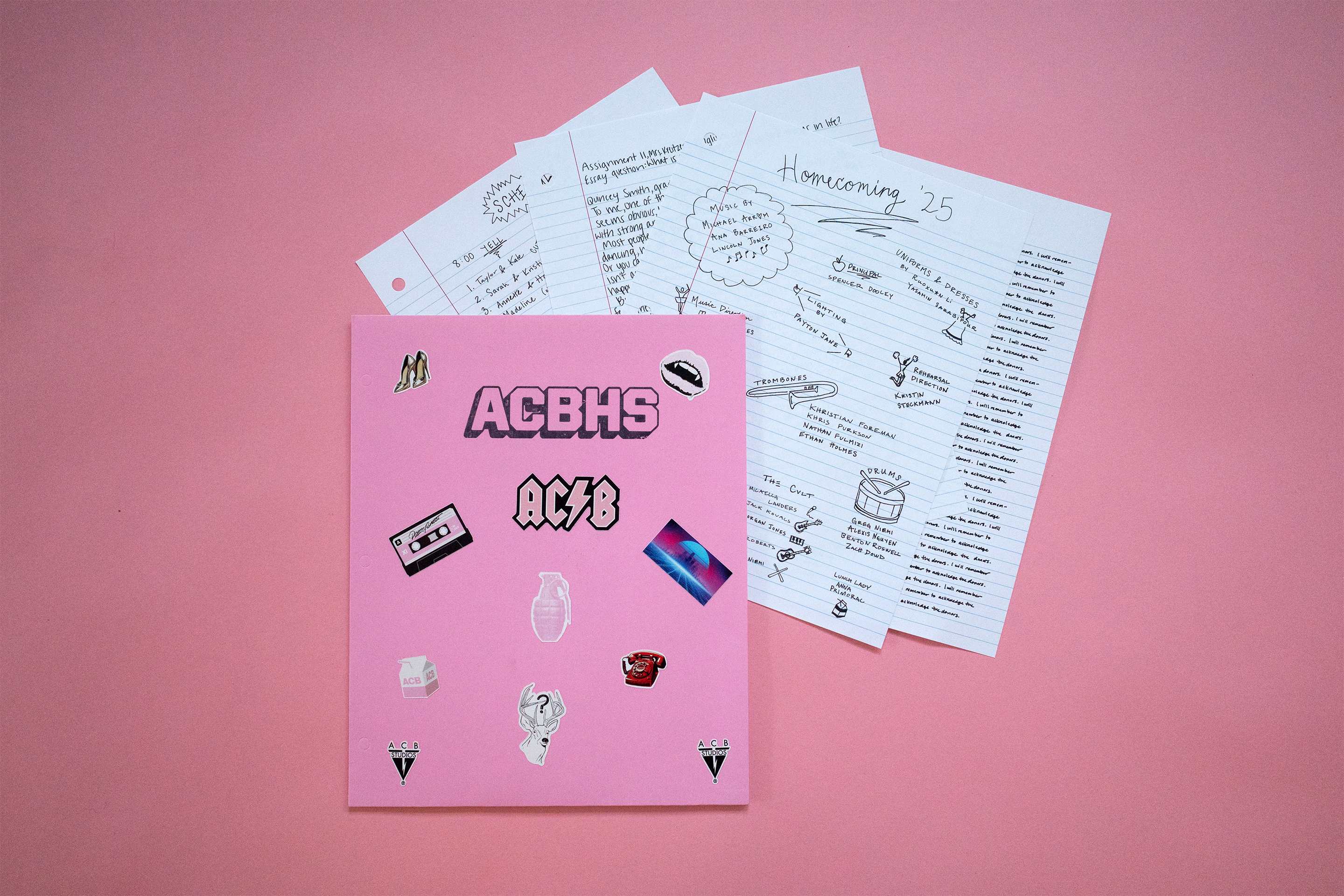 ACB homecoming program against a pink background.
