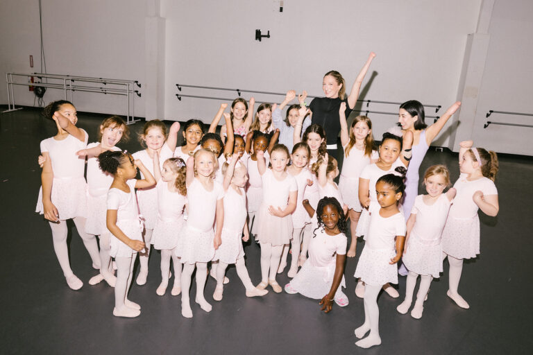 Group photo of Sydney Mesher with young dancers with limb differences dressed in ballet oufits.