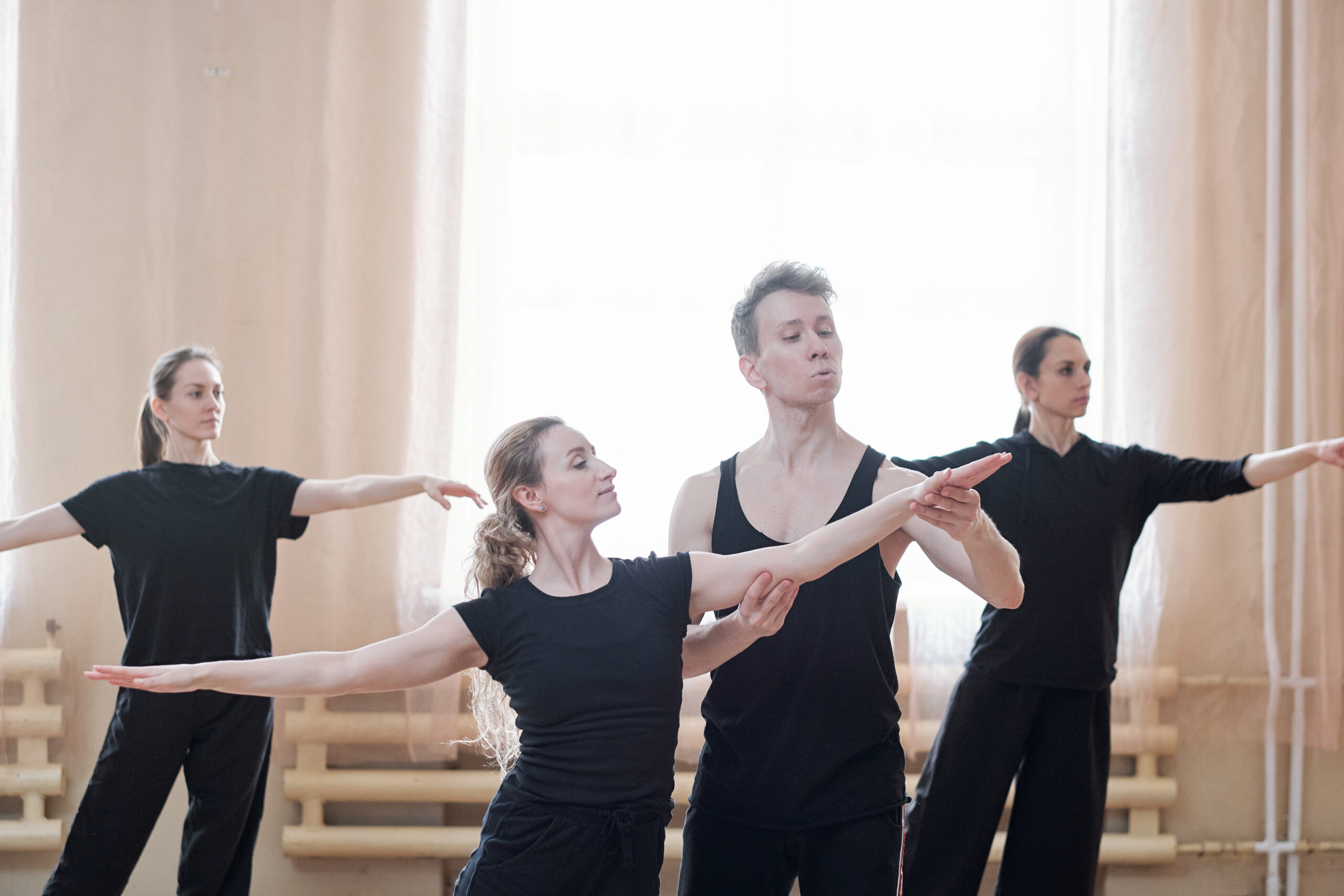 Three women rehearsing in their contemporary dance school.