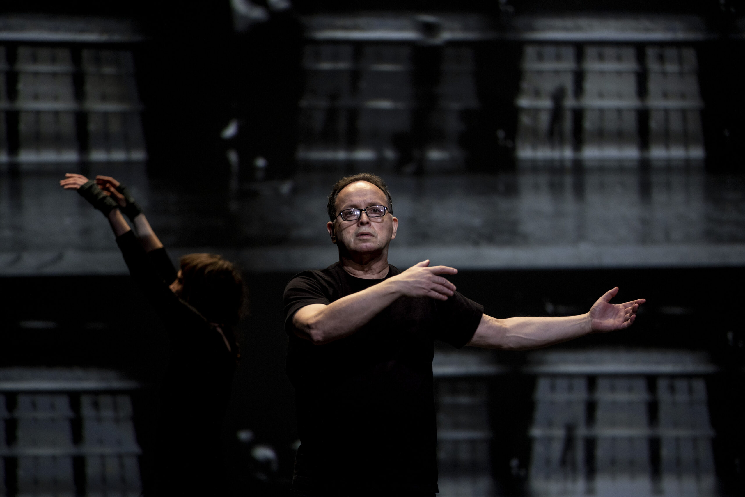 Zvi Gotheiner teaching in a dark-lit rehearsal space.