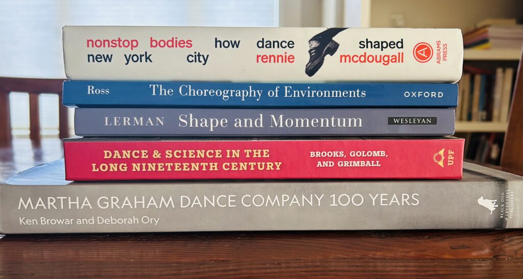 Photo of a stack of dance books laid down horizontally.