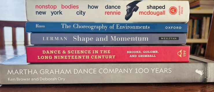 Photo of a stack of dance books laid down horizontally.